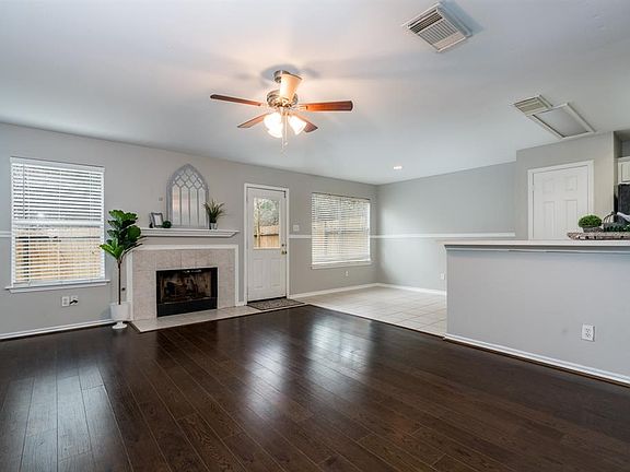 Large living space on the first floor with laminate wood flooring.