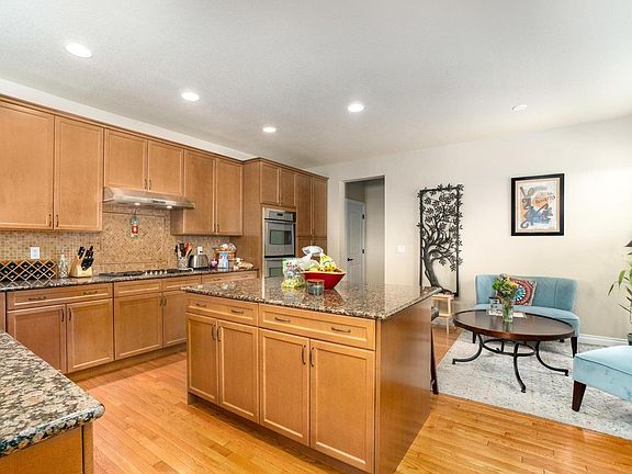 Central island, slab granite and solid wood cabinets and hardwood floors.