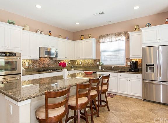 Beautiful white cabinets with granite countertops, GE Profile ss appliances, double oven, 5 burner stove, upgraded sink and faucet, walk in pantry, island . . . the list goes on!