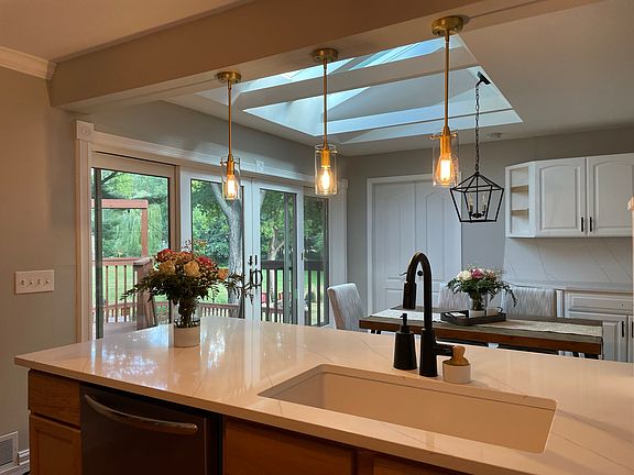 Kitchen counter with updated counters and cabinets. Beautiful sunlight and access to the patio.