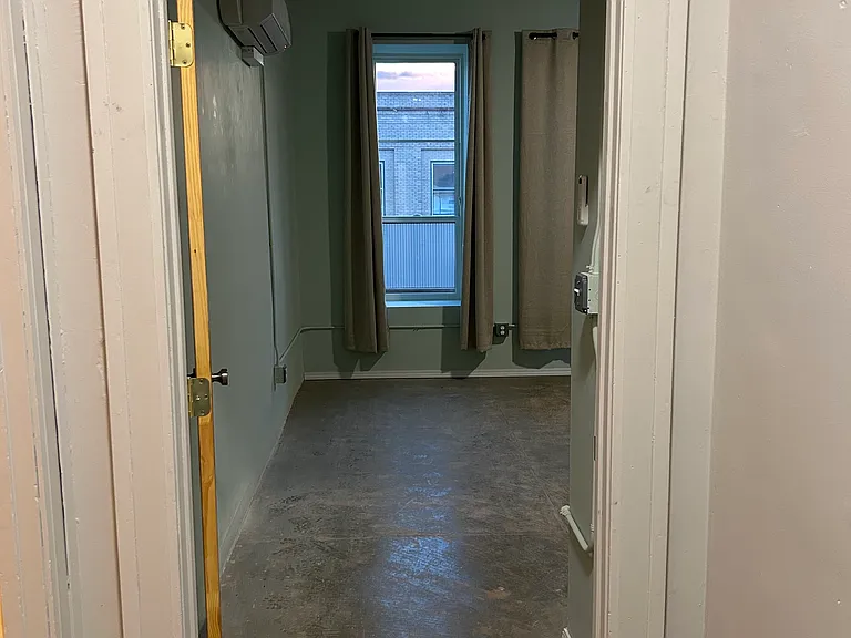Hallway between kitchen/dining areas, bedrooms, and bathroom -- looking into Bedroom #1.