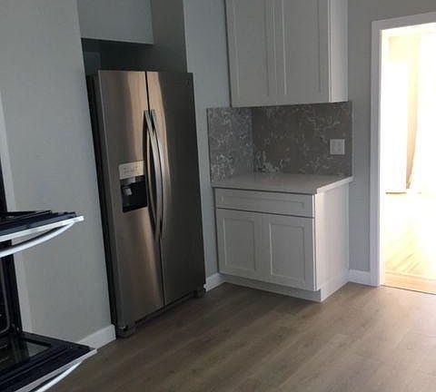 Double door 30" wide fridge/freezer with automatic ice and water in door.