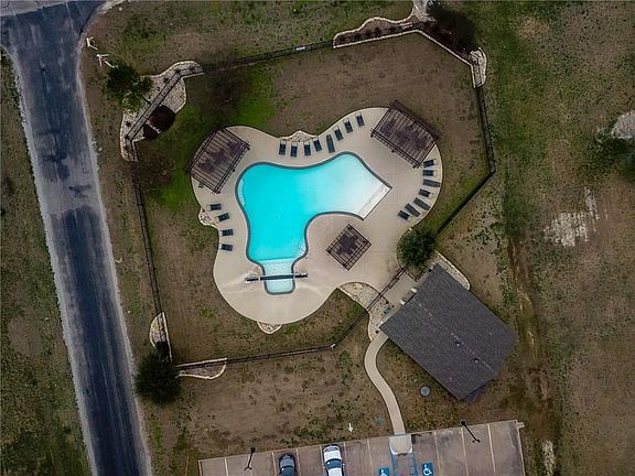 Aerial shot of waterfall pool with restrooms and showers.