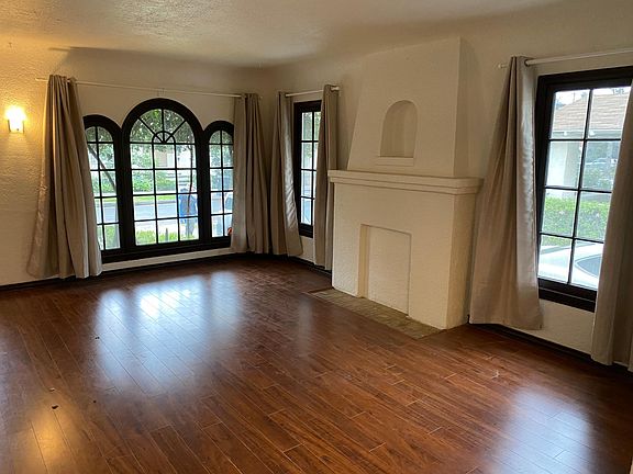 Living room with spanish style stucco and original windows