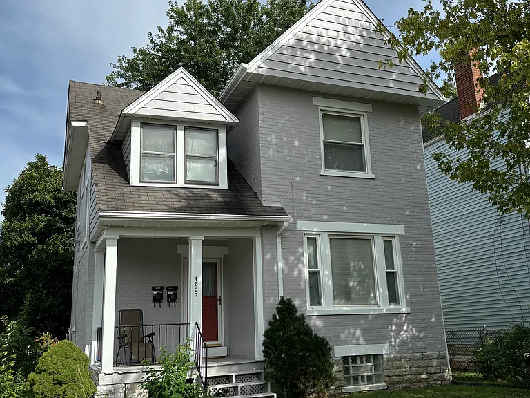Front elevation of the duplex. Access to unit 1 is in the back of the building (yellow door)