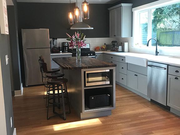 Large kitchen with high ceiling, gas range and island