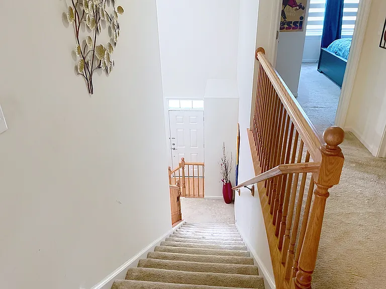 Stairway to the loft with the view of one of two 2nd floor bedrooms