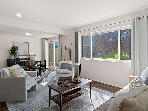 Brightly lit living and dining room.