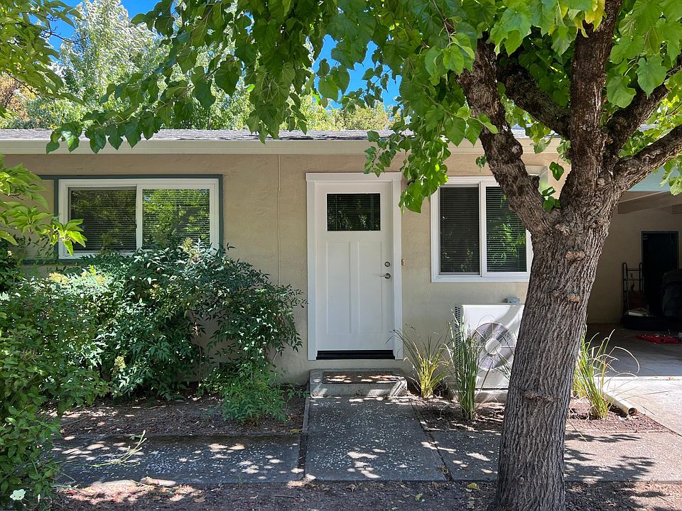 Front door. To the right is the covered, off-street parking spot and locking storage closet.