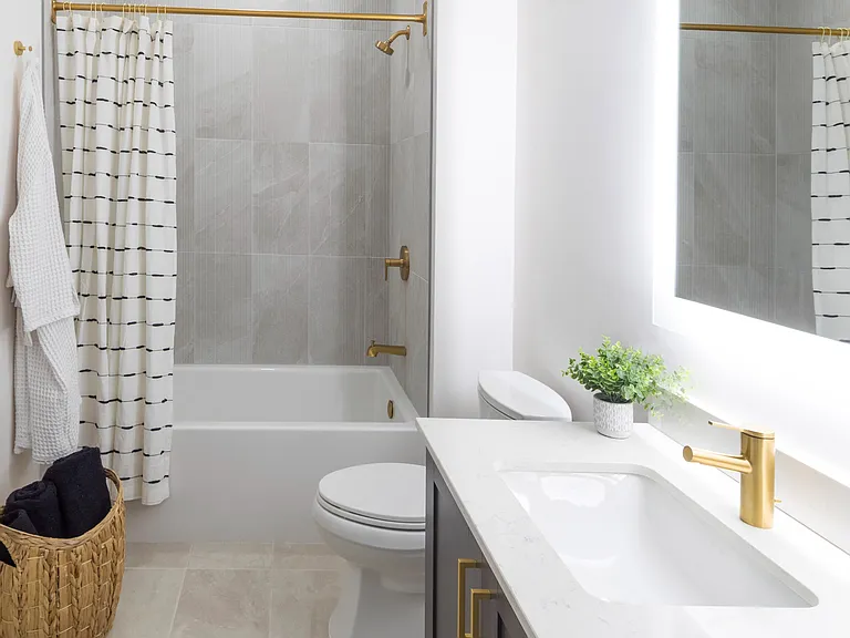 Serene bathroom featuring an LED backlit mirror and premium fixtures