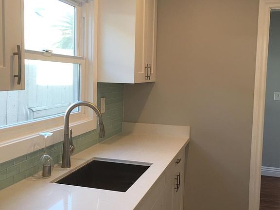 Sink side of galley kitchen with dishwasher