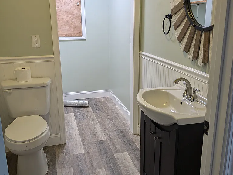 Half bath accessed from living/dining/kitchen area with laundry room attached
