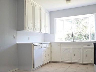 White, Bright and Spacious. Easy cleaning tile flooring and cabinets galore