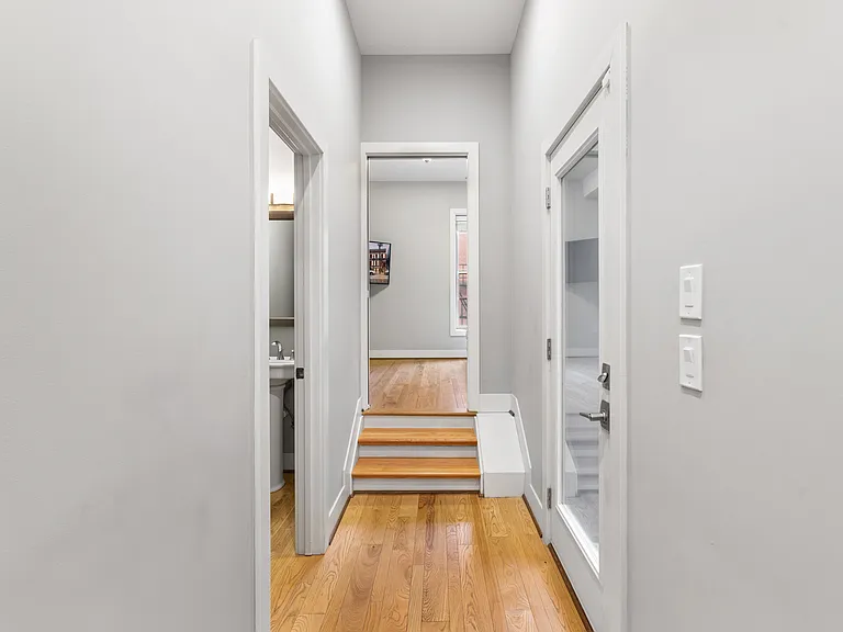 First floor - view from kitchen toward rear of the floor, bathroom on left and patio door on right with the Study straight ahead.