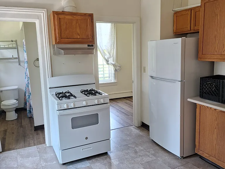 Home sized stove and refrigerator. Plenty of space for the kitchen table and chairs.