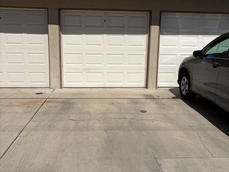 Middle garage (alley side) with single car tandem parking behind it.