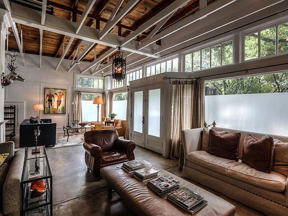 Open trussed ceiling, original store front windows and doors provide privacy as well as abundant lig