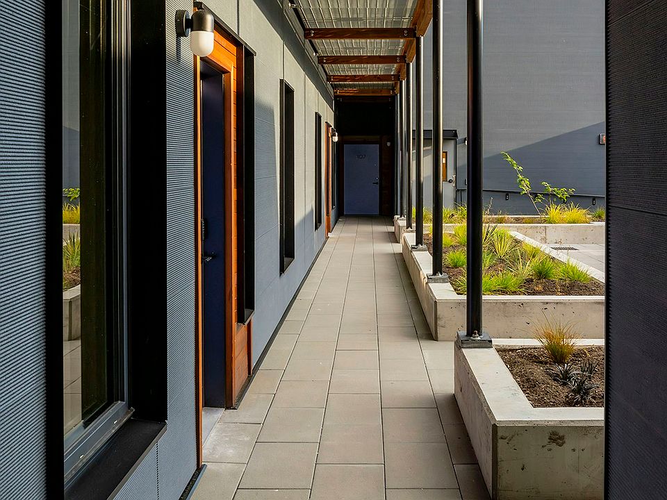 A landscaped courtyard awaits just inside the front gate. Relax, read, or socialize surrounded by vegetation in an urban oasis.