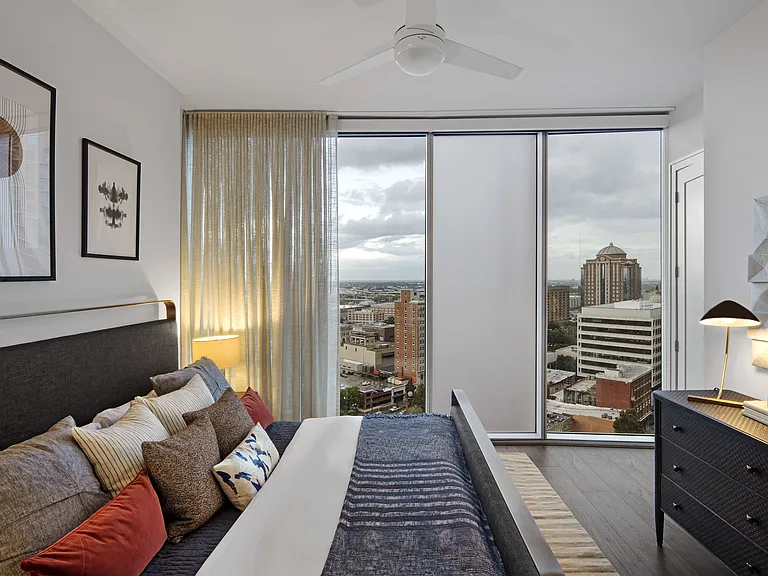 Wake up to skyline views in a bedroom designed for comfort and calm.