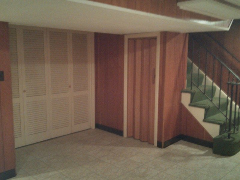 Finished Rec Room : Paneled rec room - new floor - laundry room also paneled beyond folding doors