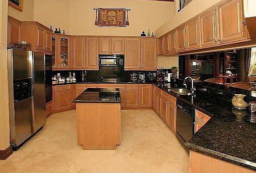 Gourmet Kitchen with Island and Double Ovens and Granite Counter Tops