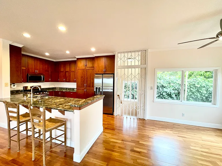 Kitchen, dining area & security gate at top of interior stairs
