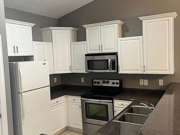 Kitchen with drop down cabinets and raised bar for additional seating.