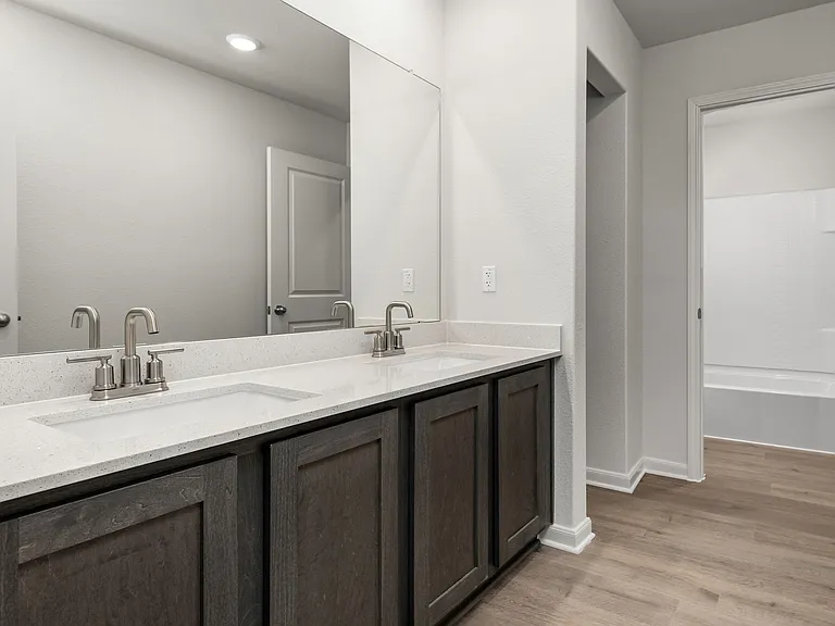 The secondary bathroom has a large vanity space.