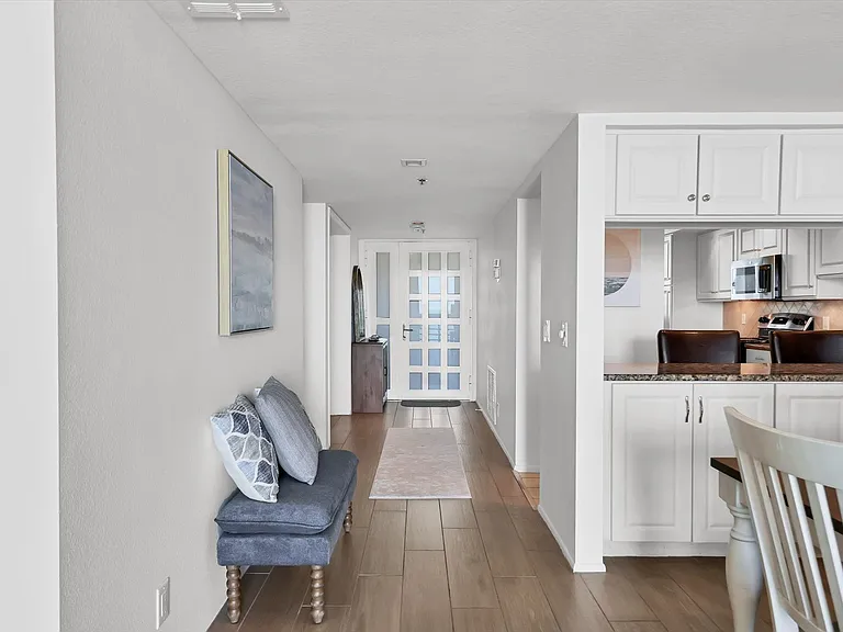 Entry way appointed with new furnishings with storage and seating options