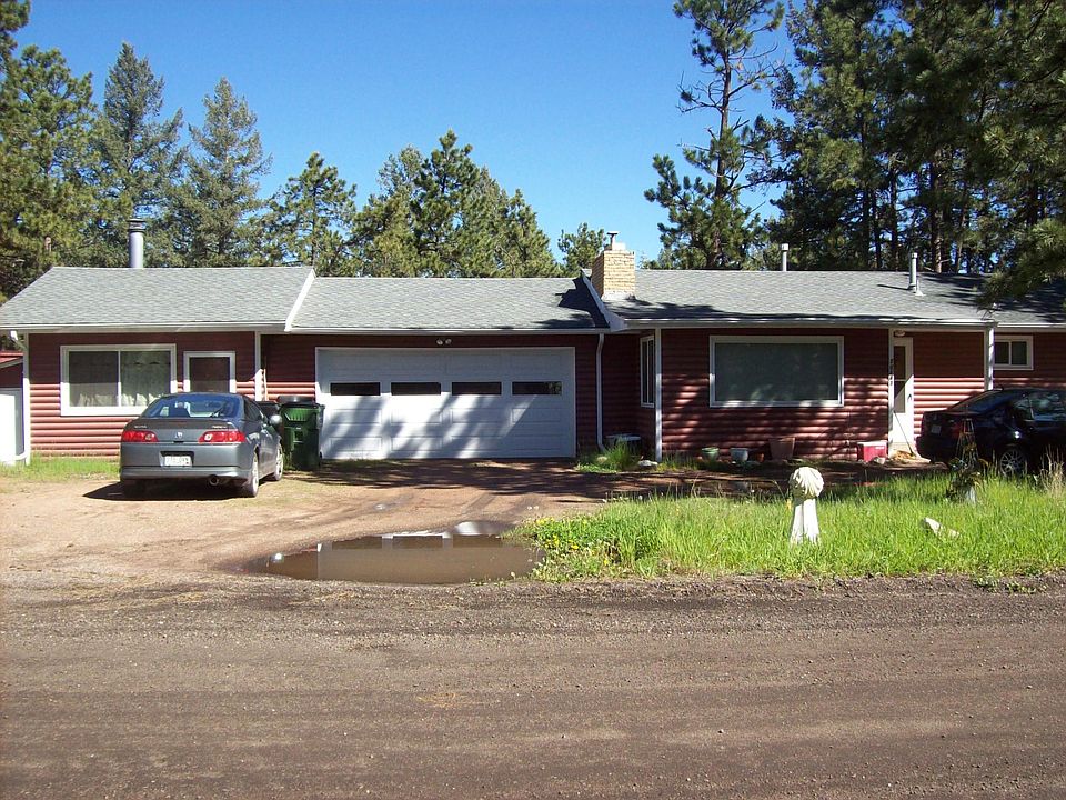 Front elevation: Den on left, garage, primary living area