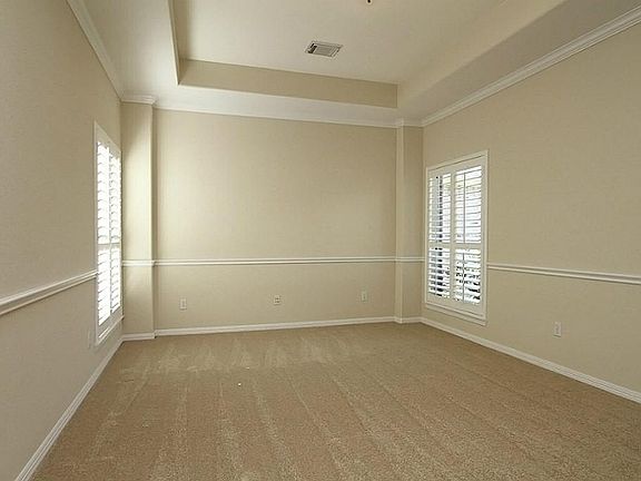 THIS 17X12 FORMAL DINING ROOM FEATURES A TRAY CEILING AND BOTH CROWN & CHAIR MOLDING. WINDOWS ON 2 SIDES PROVIDE LOTS OF NATURAL LIGHT AND HAVE CHARMING PLANTATION SHUTTERS.