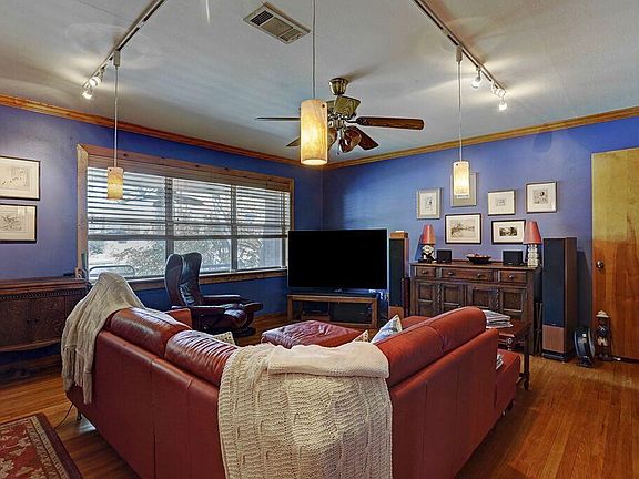 Inviting Family room with lots of lighting to showcase your art work