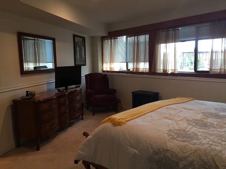 Bedroom with several windows.