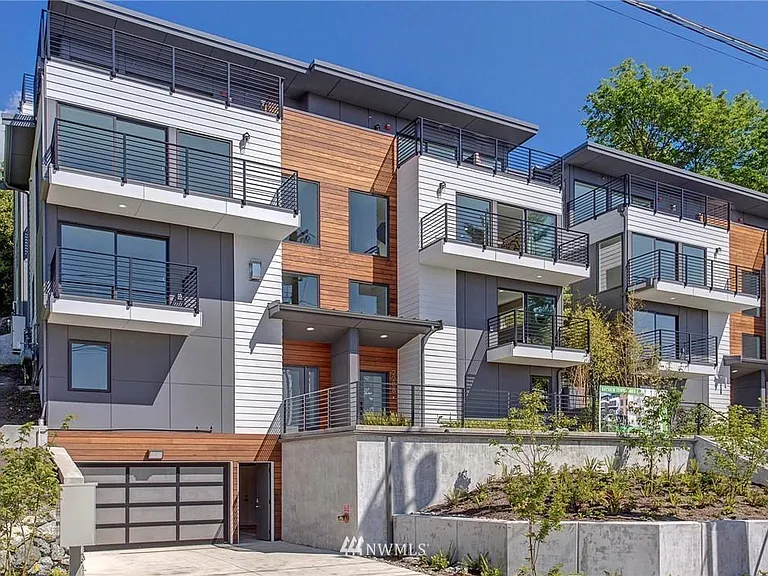 Built in 2020 in West Queen Anne, this contemporary townhome offers four levels of living space and Secure garage.