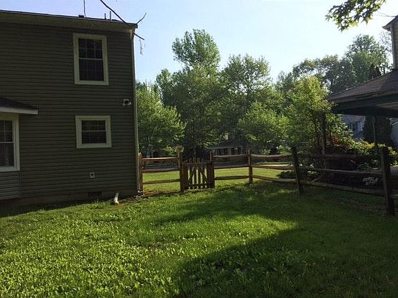 The Backyard fenced with gates on both sides of the yard.