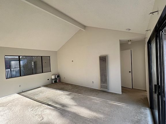Living room viewed from dining room. Utility closet in hallway.