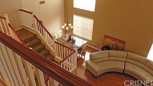 UPSTAIRS HALL LOOKING DOWN TO LIVING DINING AREA
