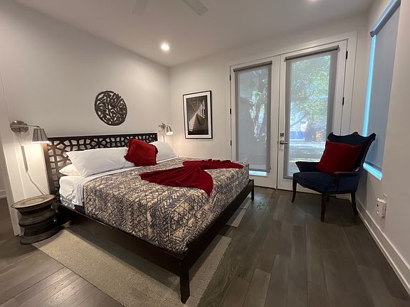 Primary bedroom w/ french doors that provide access to the backyard space and carport