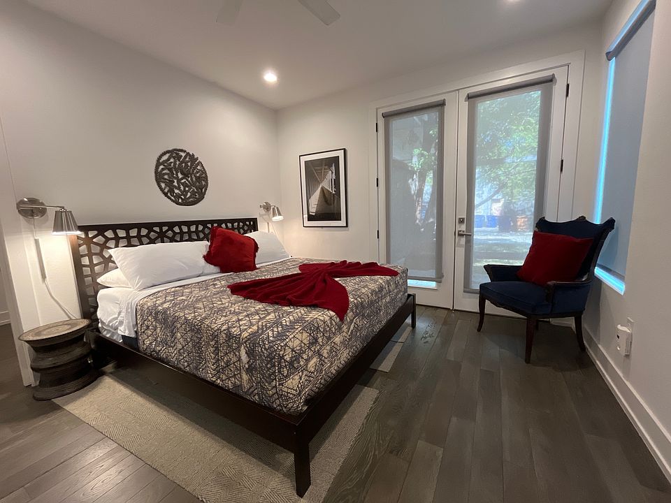 Primary bedroom w/ french doors that provide access to the backyard space and carport