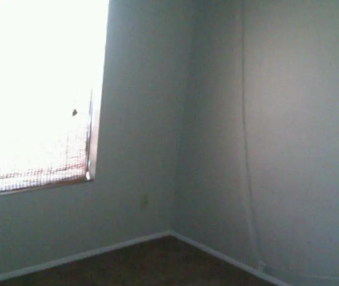 One side of 2nd bedroom wall with 1 walkin closets and fans.