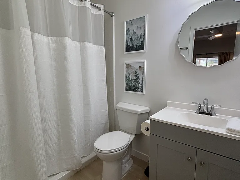 Private ensuite bathroom with a shower and updated vanity.