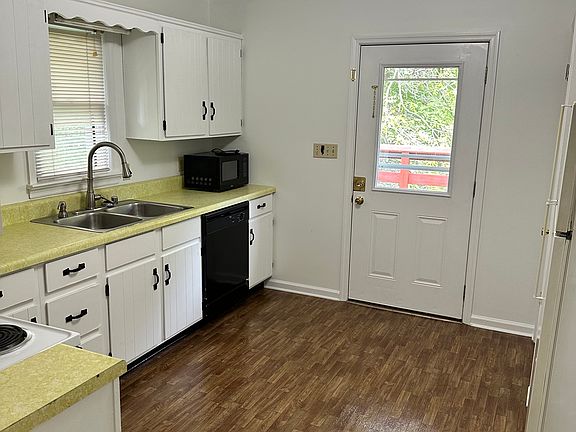 Kitchen with refrigerator, stove, microwave and dishwasher.