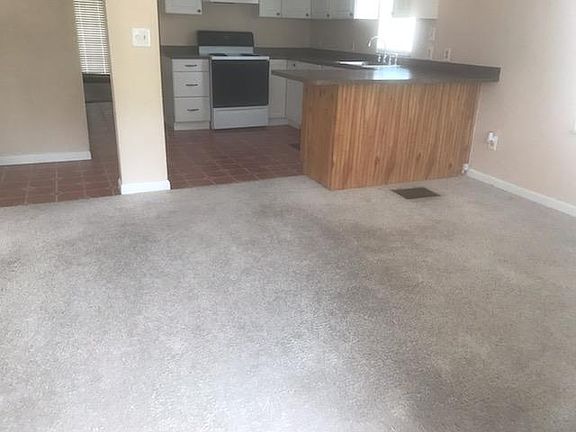 Photo taken from the front door. Dining area on the right, shared by the living room on the left.