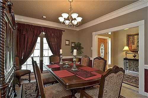 Formal dining has tile, crown molding, chair rail and detailed trim work.