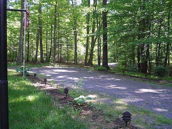 The front of the house is bright yet shady in the summer