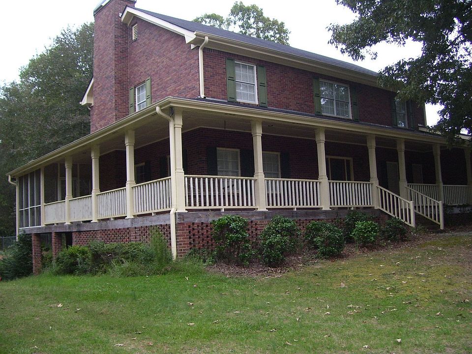 All brick features large wrap around porch