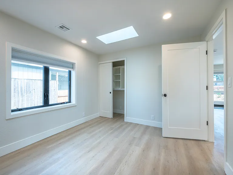 Bedroom #2 , closet organizers w/ 2 skylights and large window.