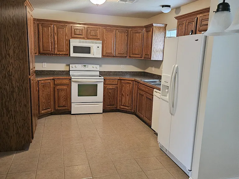 Kitchen with refrigerator, stove, microwave, diswasher