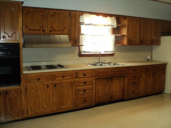 Large kitchen with nice amount of cabinets. Electric cook top stove and built in oven