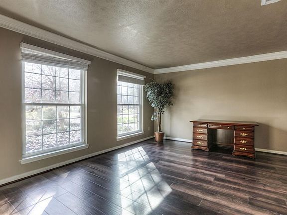 Formal Living w/ Crown Molding and huge windows providing an abundance of natural lighting